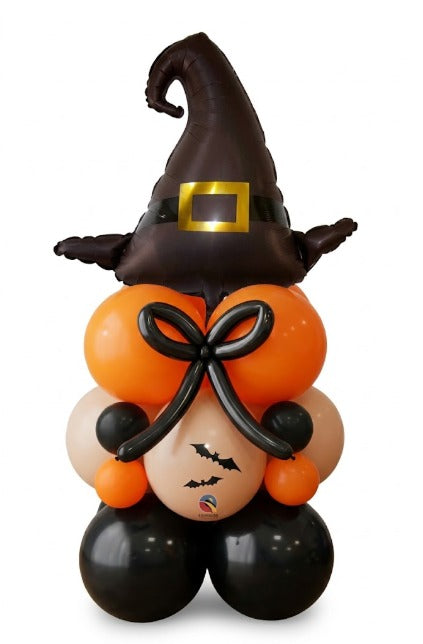 Halloween witch balloon figure with a black witch hat balloon on an orange, ivory and black balloon body