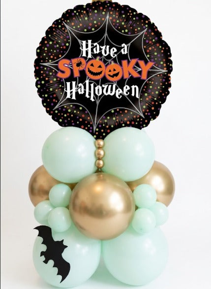 Halloween balloon stand in mint green and chrome gold with a foil balloon printed Have a Spooky Halloween