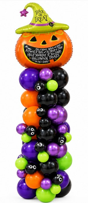 Halloween balloon column in purple, black, orange and green topped with a pumpkin balloon in a Trick or Treat witch hat