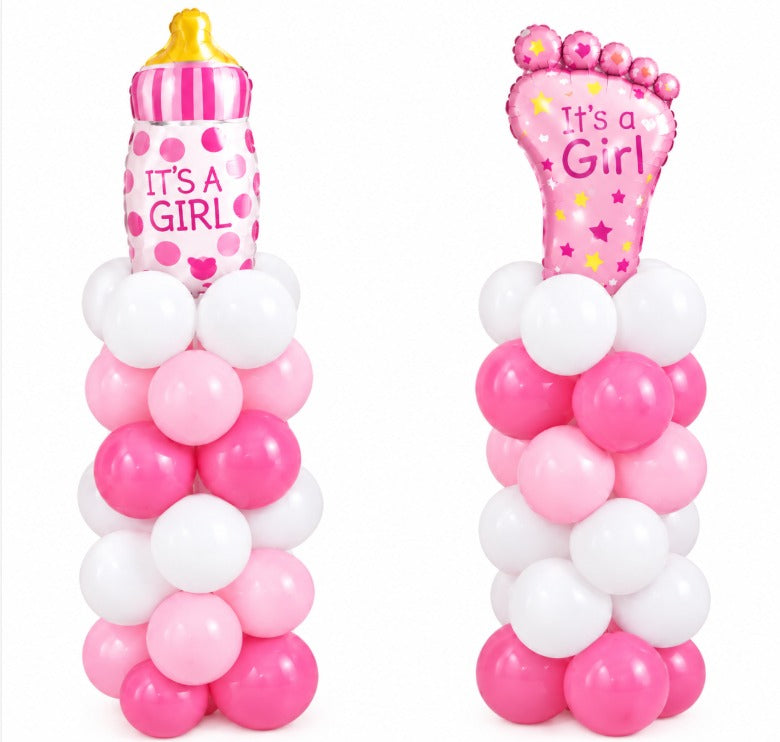 Two pink and white balloon pillars topped with It's a Girl baby bottle and baby foot foil balloons