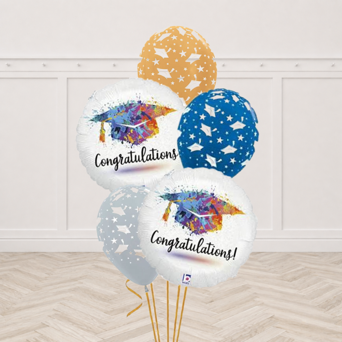 Two white Congratulations round foil balloons featuring a colourful splash art graduation cap with three gold, blue and silver latex balloons
