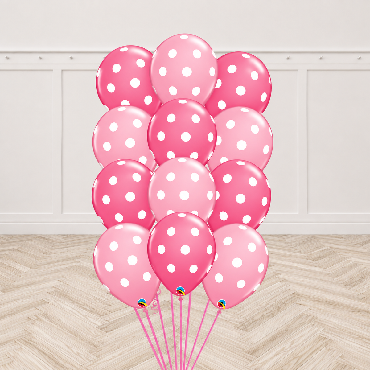 Twelve two-tone pink latex balloons printed with white polka dots, tied together in a bouquet