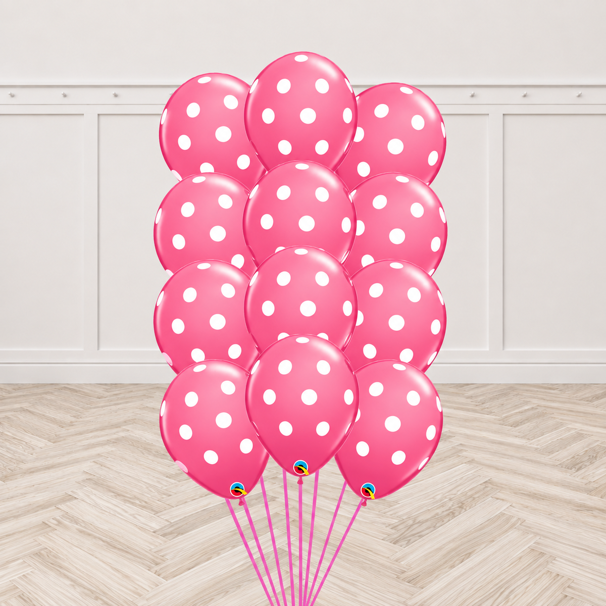 Twelve two-tone rose and pink latex balloons printed with white polka dots, tied together in a bouquet