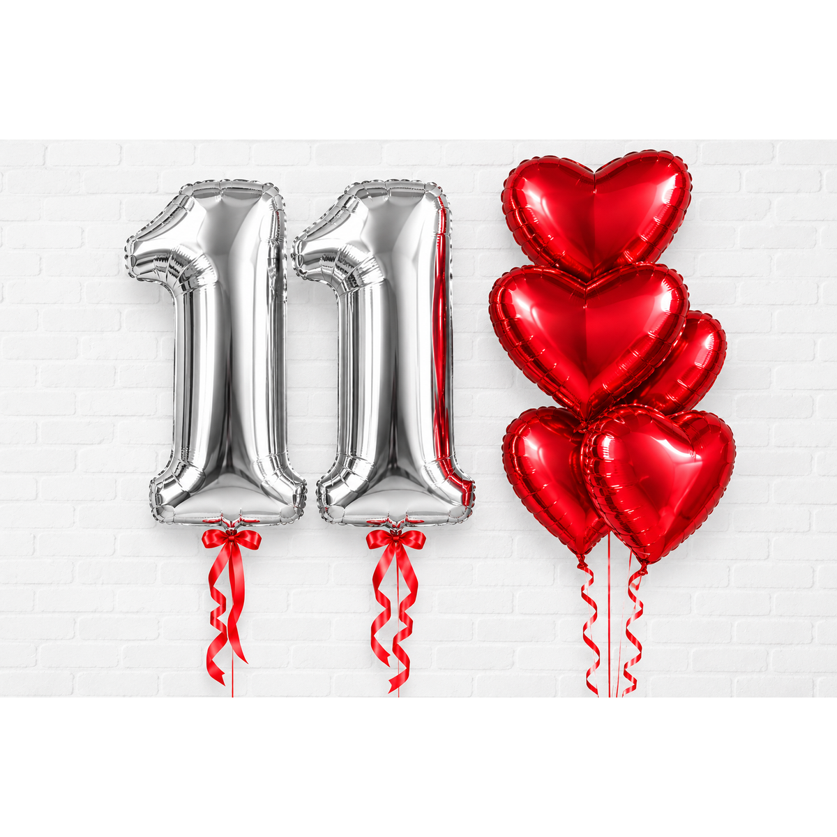 Silver number foil balloons with ribbon bows and red heart foil balloon bouquet on holder