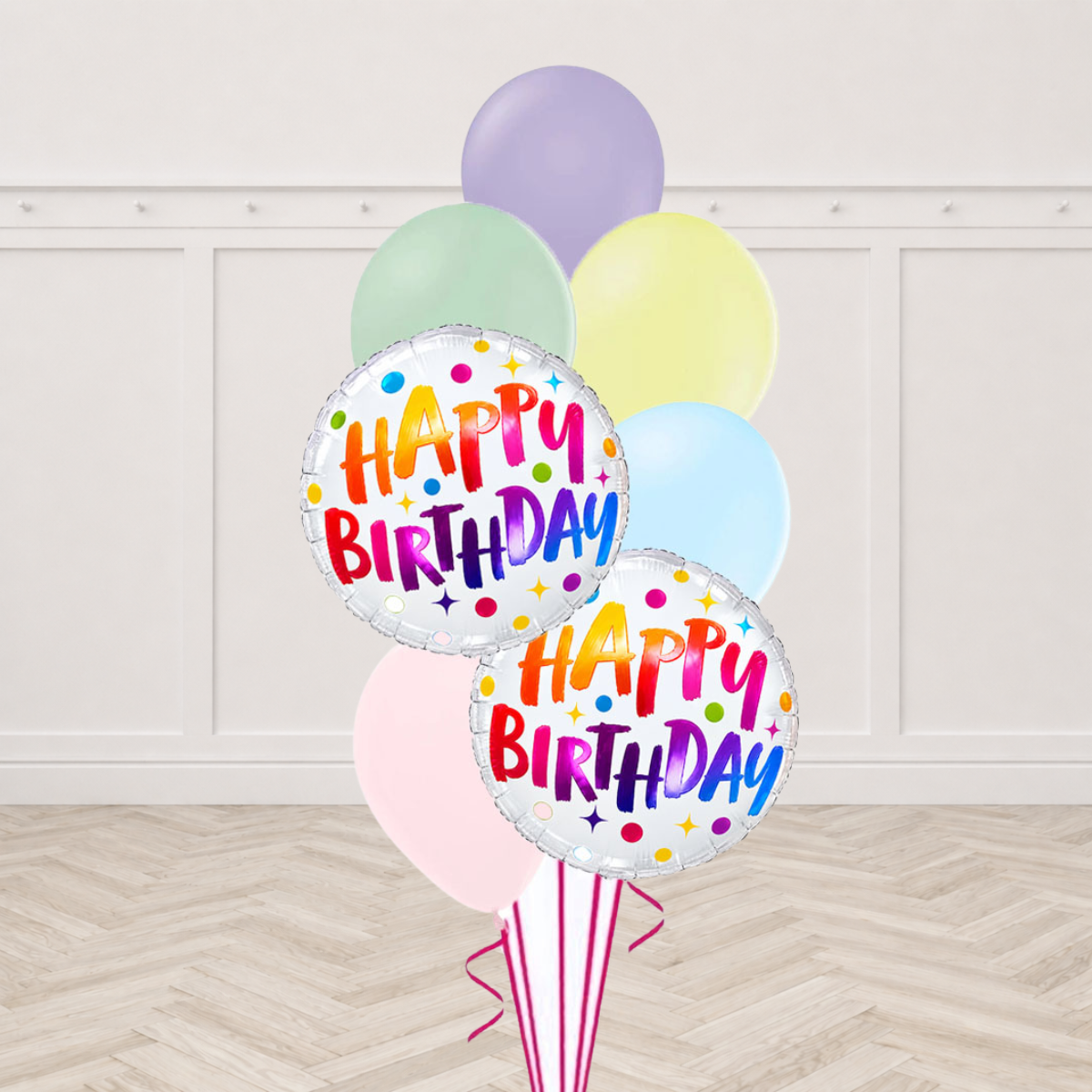 Two rainbow Happy Birthday foil balloons with pastel latex balloons
