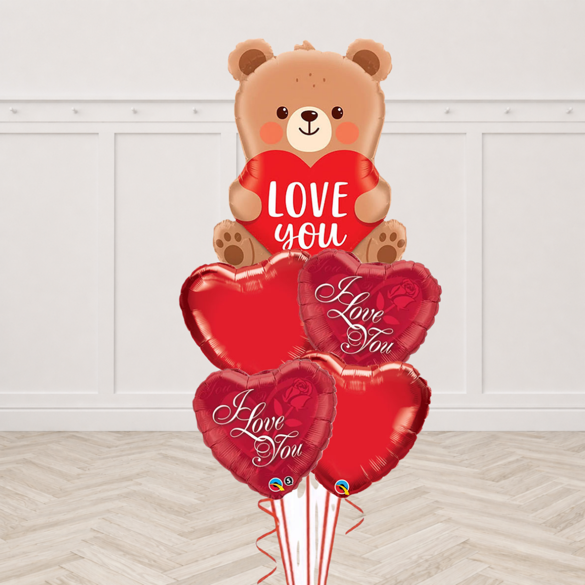Teddy bear foil balloon holding a Love You heart with red heart foil balloons and I Love You heart foil balloons
