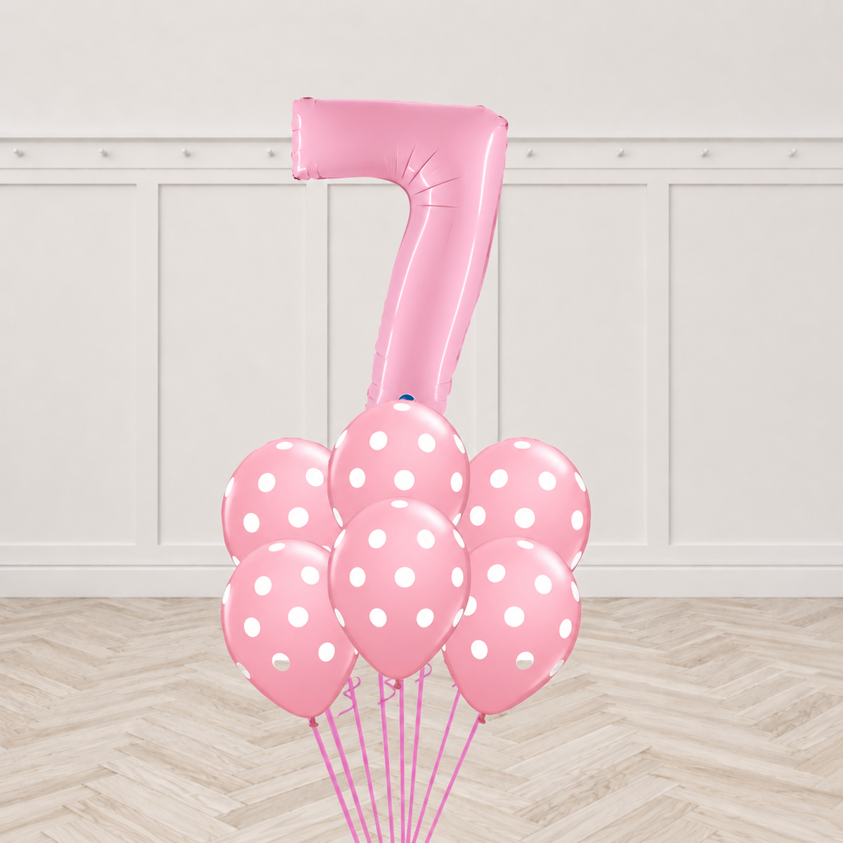 Pink number foil balloon with six pink polka-dot latex balloons in a bouquet