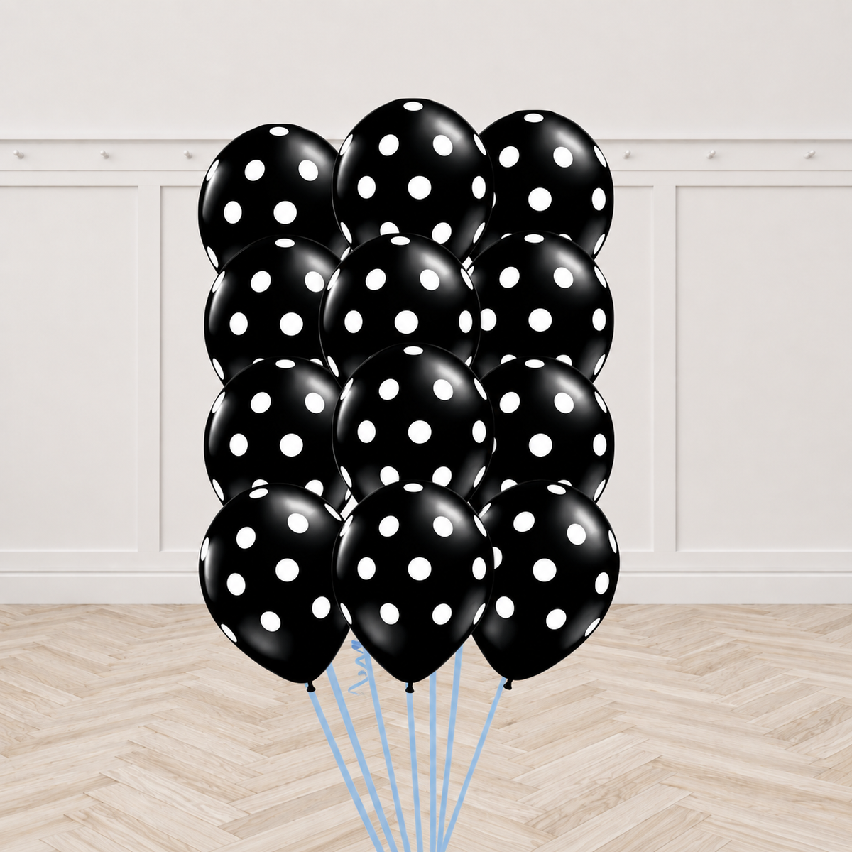 Twelve black latex balloons printed with white polka dots, tied together in a bouquet