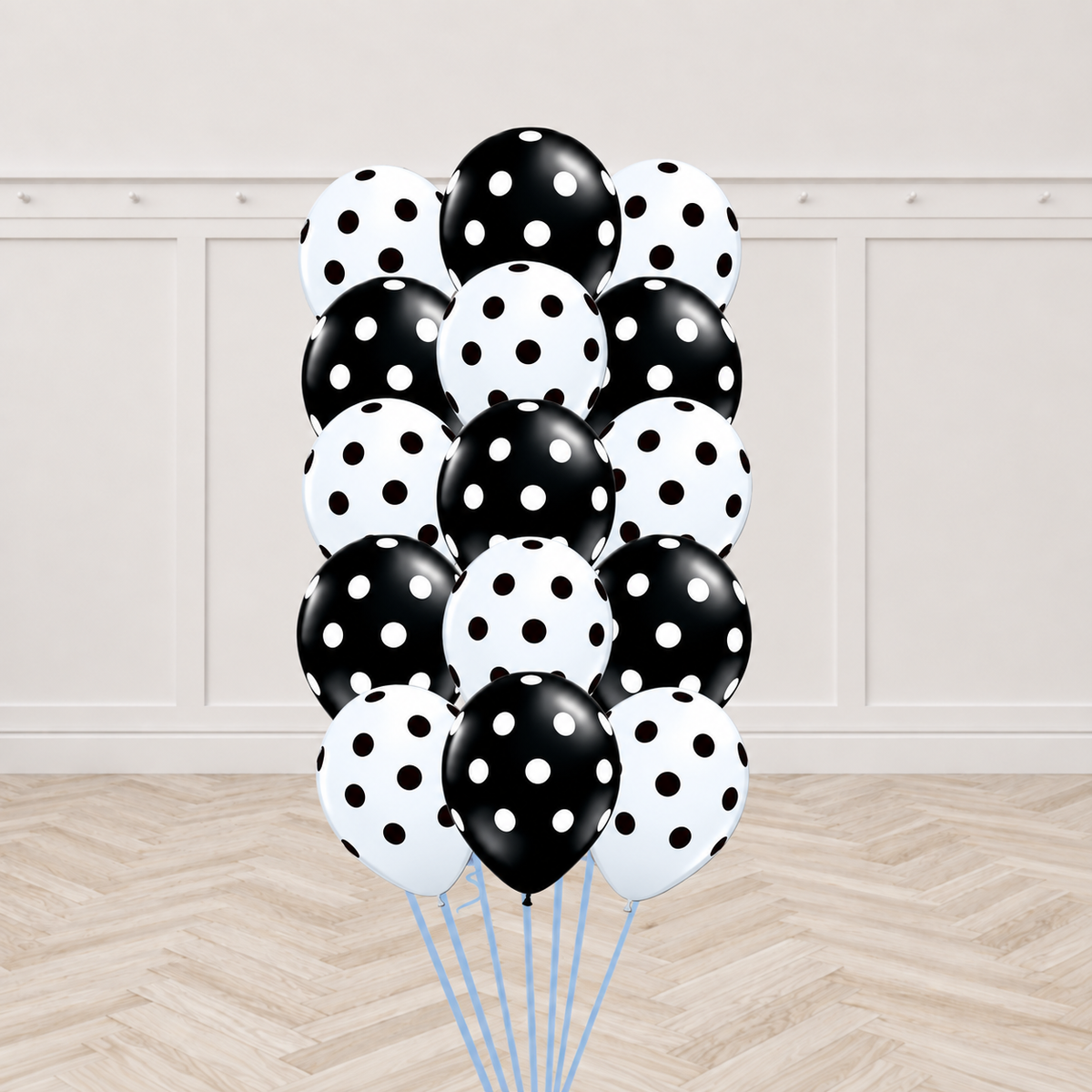 Fifteen mixed black and white latex balloons printed with polka dots, tied together in a bouquet