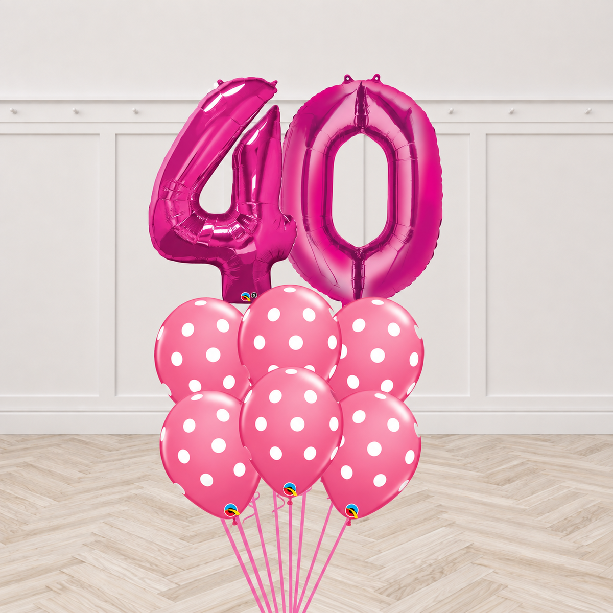 Two magenta number foil balloons forming a two-digit age with six pink polka-dot latex balloons