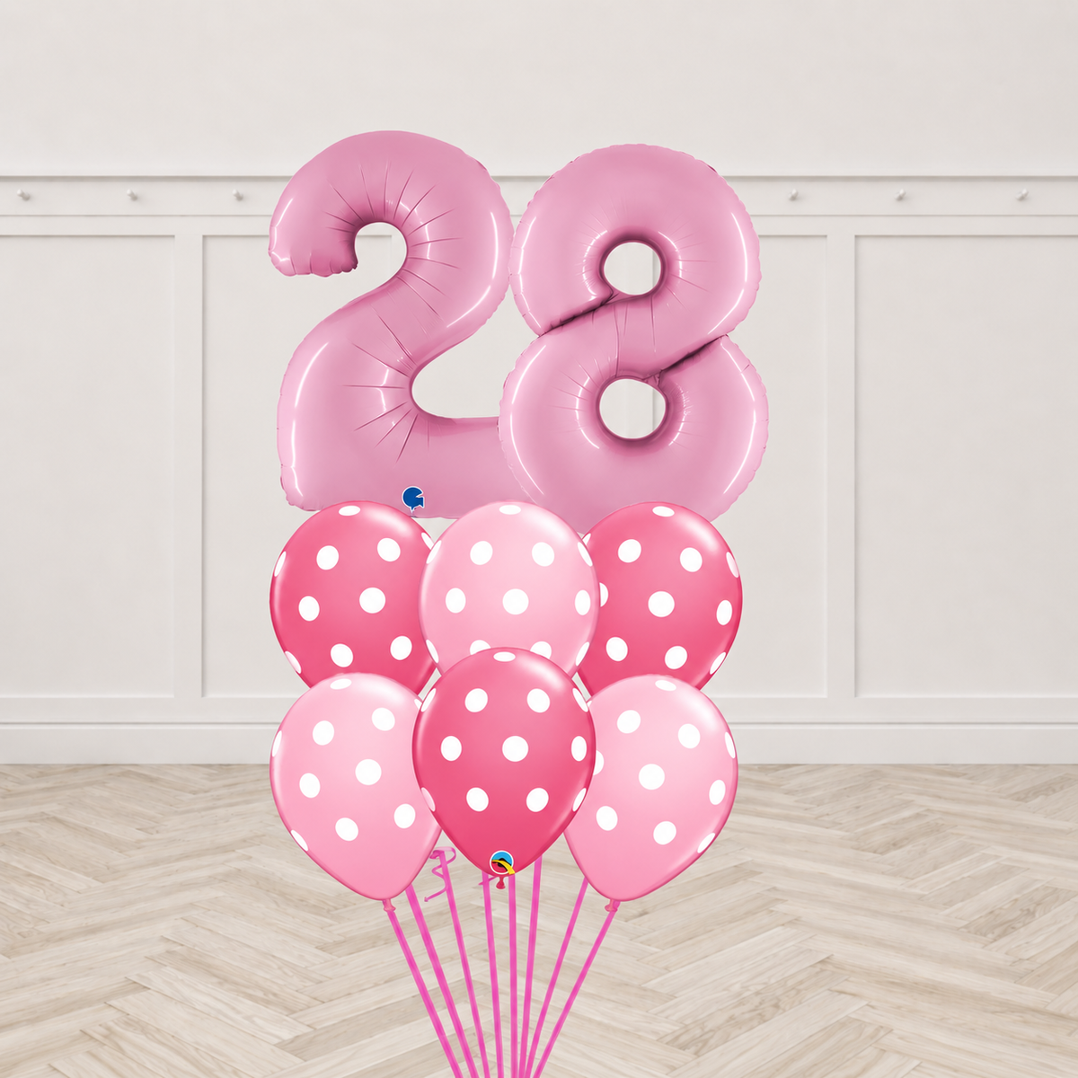 Two dusty pink number foil balloons forming a two-digit age with six two-tone pink polka-dot latex balloons