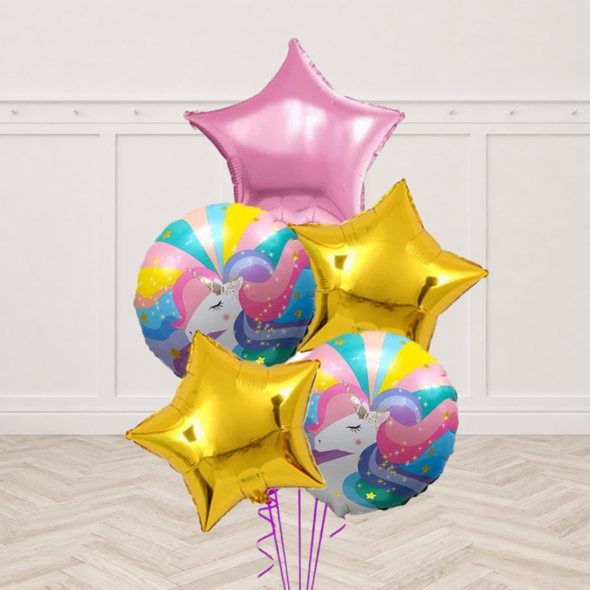 Two round unicorn print foil balloons with one pink star foil and two gold star foils on purple ribbons