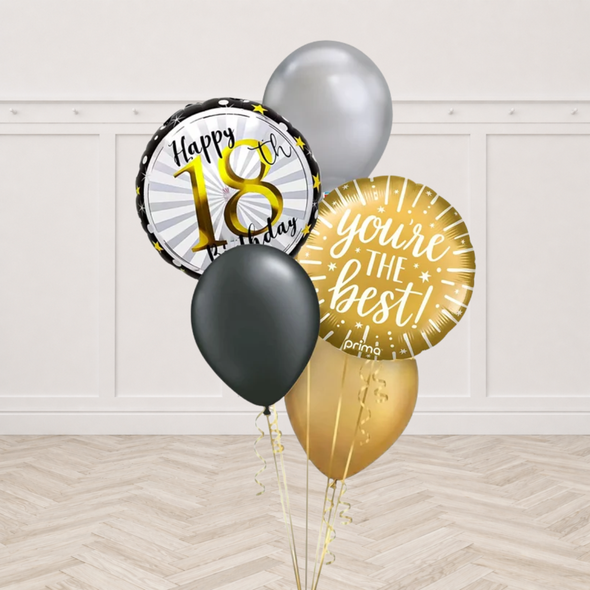Round Happy 18th Birthday foil balloon with gold 18 and a gold round foil balloon printed you're the best with silver black and gold latex balloons on gold ribbons