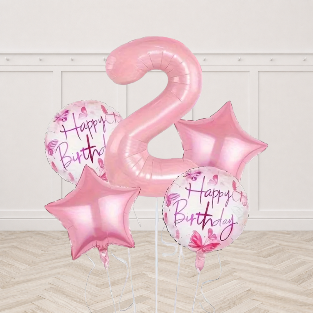 Light pink number 2 foil balloon with two white round foil balloons printed Happy Birthday with pink and purple butterflies and two light pink star foils on white ribbons