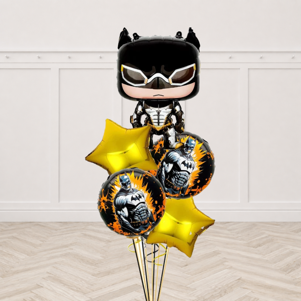 Batman shaped foil balloon with two black and orange round Batman foil balloons and two gold star foils on gold and black ribbons