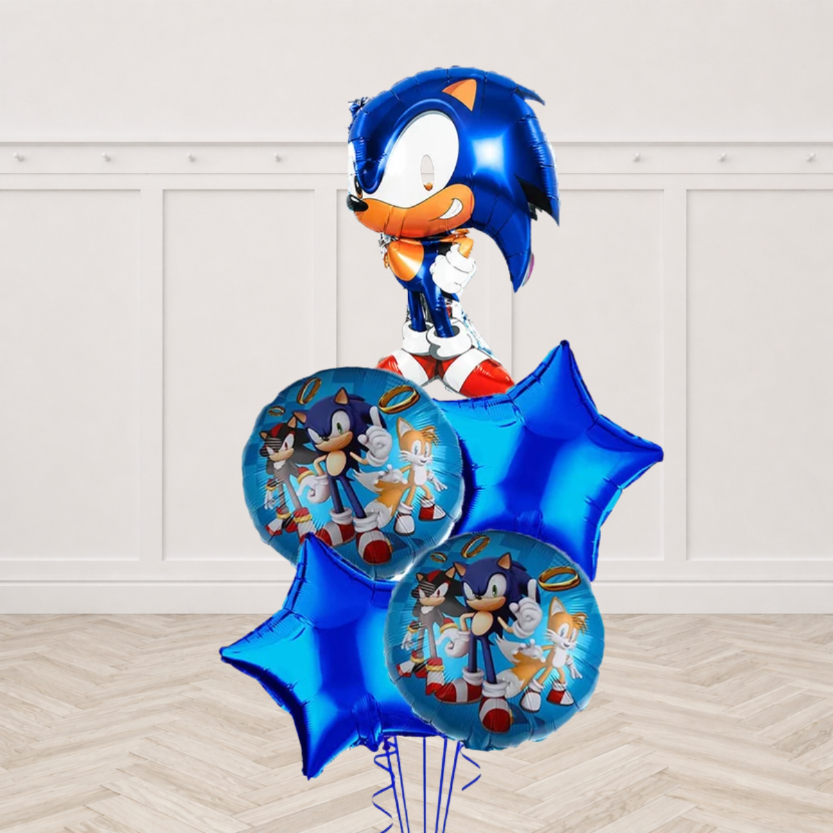 Sonic shaped foil balloon with two blue round foil balloons printed with Sonic Tails and Shadow and two blue star foils on blue ribbons